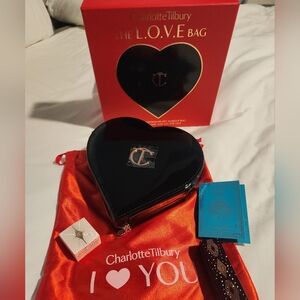 Charlotte Tilbury Heart-Shaped Black Bag with Red Pouch .
